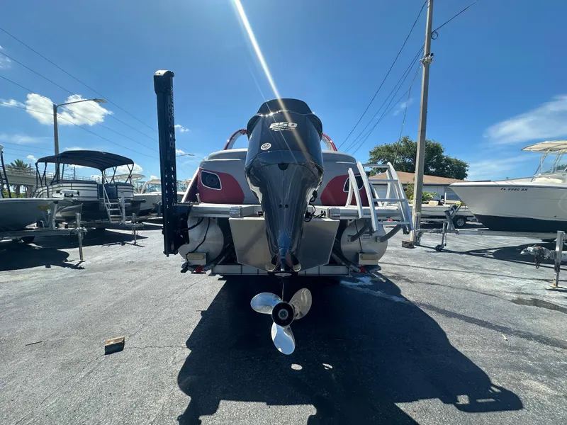 Slide: The Image of 2020 Bennington R 24 RTFBA boat with outboard motor in a sunny marina. - 9