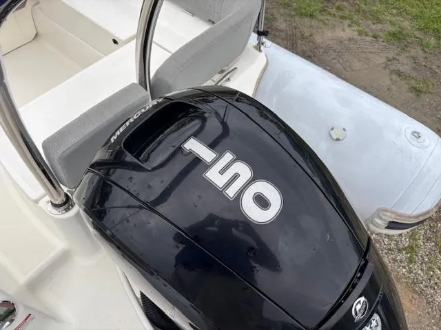 Slide: The Image of 2023 Zodiac NZO-680 boat with Mercury 150 outboard motor, rear seating visible. - 12