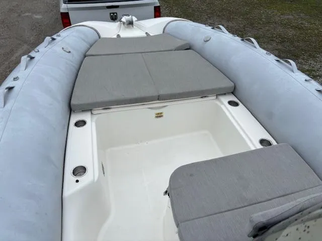 Slide: The Image of 2023 Zodiac NZO-680 inflatable boat with gray seating and spacious interior. - 19