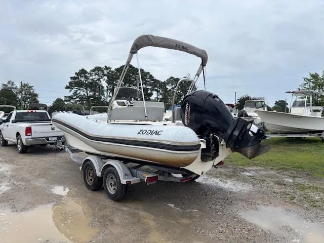 Slide: The Image of 2023 Zodiac NZO-680 boat on trailer, parked outdoors, overcast sky. - 3
