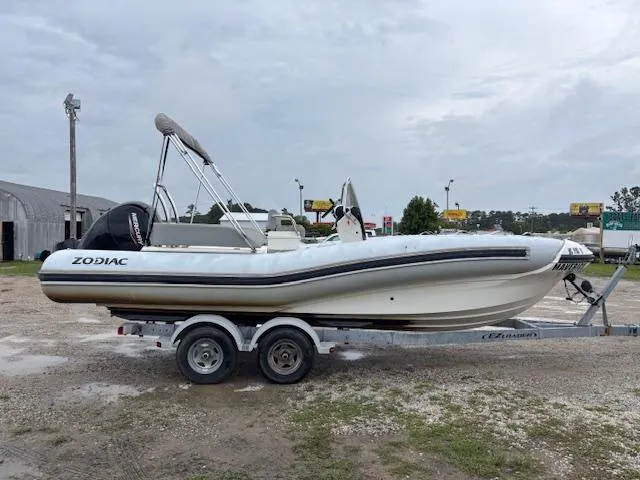 Slide: The Image of 2023 Zodiac NZO-680 boat on trailer, parked outdoors, overcast sky. - 6
