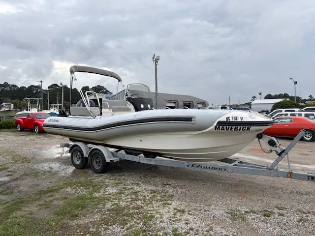 Slide: The Image of 2023 Zodiac NZO-680 boat on trailer, parked outdoors, overcast sky. - 7