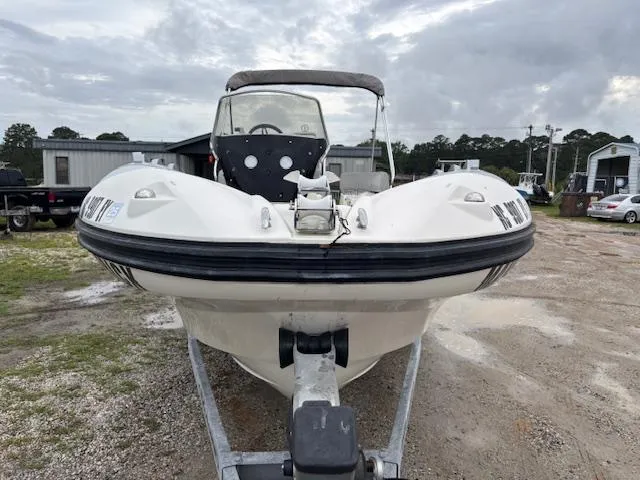 Slide: The Image of 2023 Zodiac NZO-680 boat on trailer, parked outdoors on a cloudy day. - 8