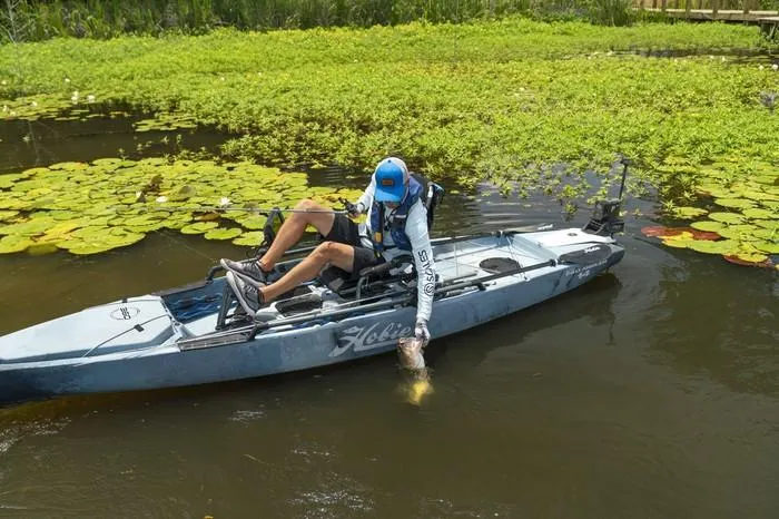 Slide: The Image of Man fishing from 2025 Hobie Pro Angler 14 kayak with 360 Drive Technology. - 3
