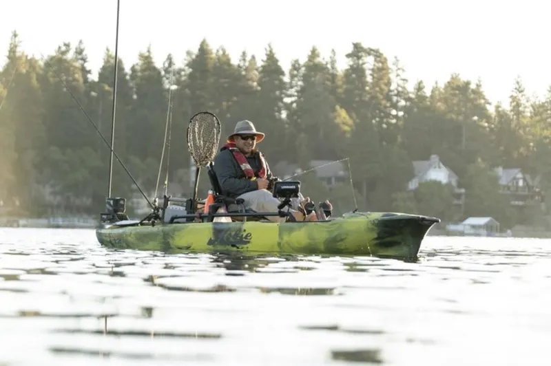 Slide: The Image of 2025 Hobie Mirage Pro Angler 12 kayak with 360 Drive on a serene lake. - 4