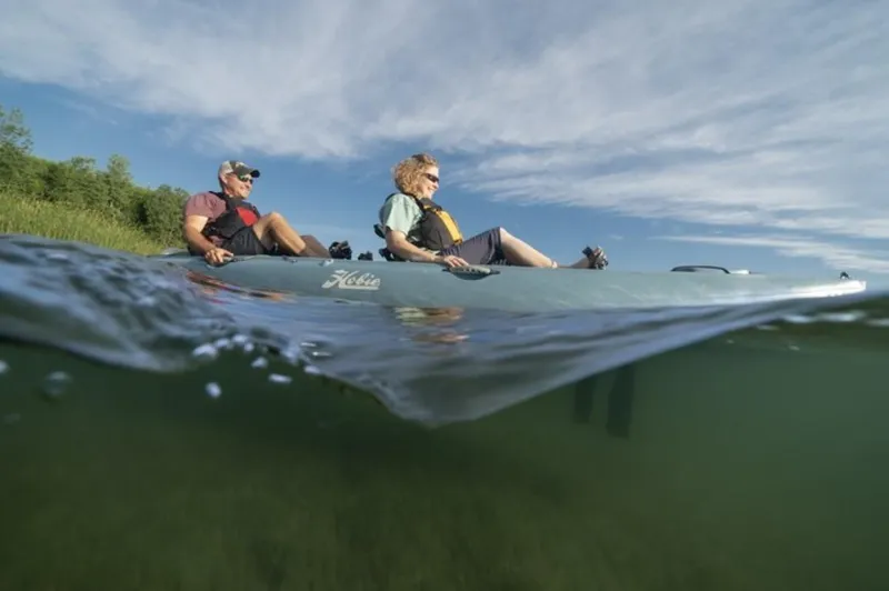 Slide: The Image of Two people kayaking on a 2025 Hobie Mirage Oasis in calm waters. - 4
