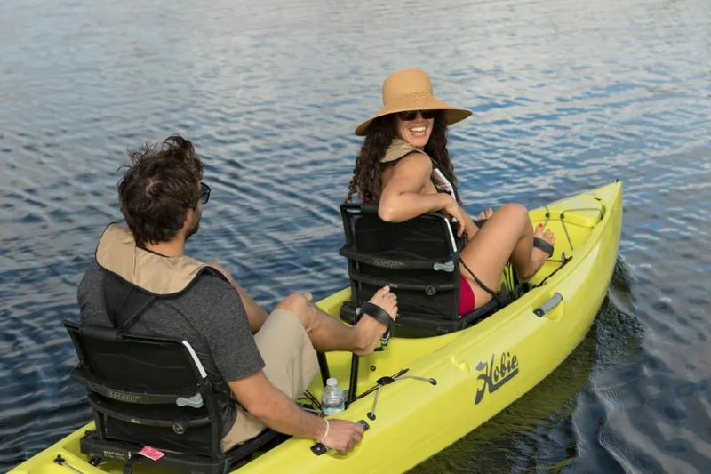 Slide: The Image of Two people kayaking on a 2025 Hobie Mirage Oasis in calm waters. - 7