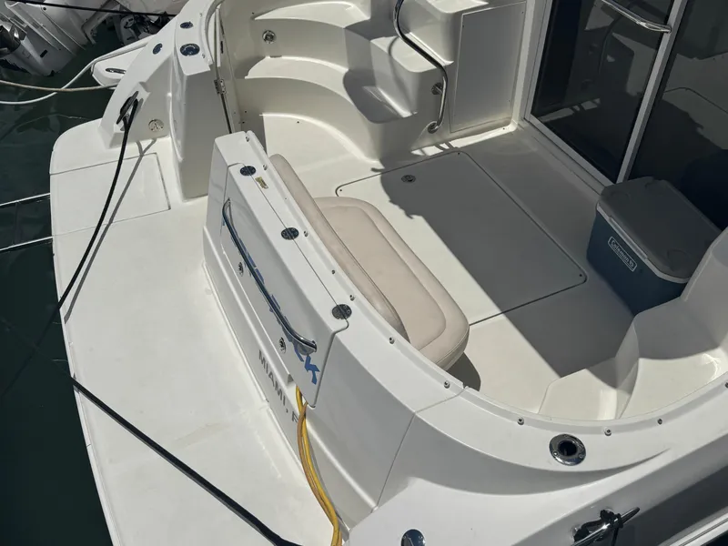 Slide: The Image of 2007 Sea Ray 360 Sedan boat deck with seating and storage, docked in sunlight. - 13