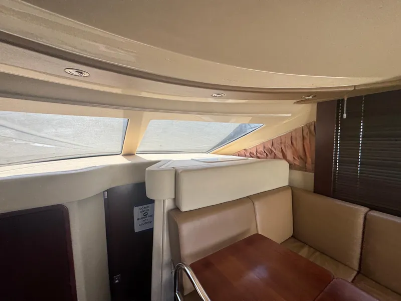 Slide: The Image of Interior of 2007 Sea Ray 360 Sedan with beige seating and wooden table. - 29