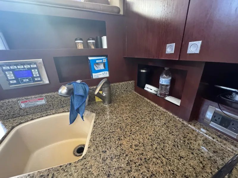 Slide: The Image of Kitchen area of 2007 Sea Ray 360 Sedan with granite countertop and sink. - 32
