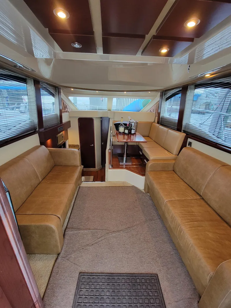Slide: The Image of Luxurious interior of 2007 Sea Ray 360 Sedan with plush seating and dining area. - 4