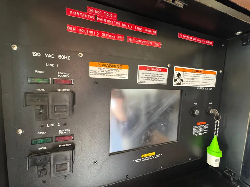 Slide: The Image of Electrical control panel of a 2007 Sea Ray 360 Sedan boat with warning labels. - 42