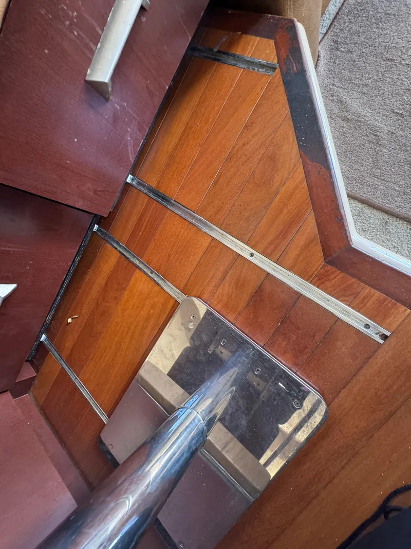 Slide: The Image of Wooden interior of a 2007 Sea Ray 360 Sedan boat, featuring polished metal accents. - 44