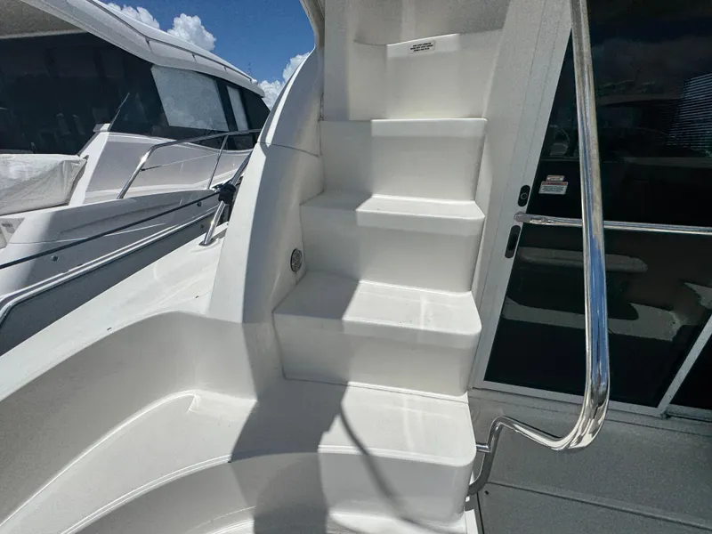Slide: The Image of Staircase on a 2007 Sea Ray 360 Sedan yacht, featuring sleek white design and stainless steel railing. - 49