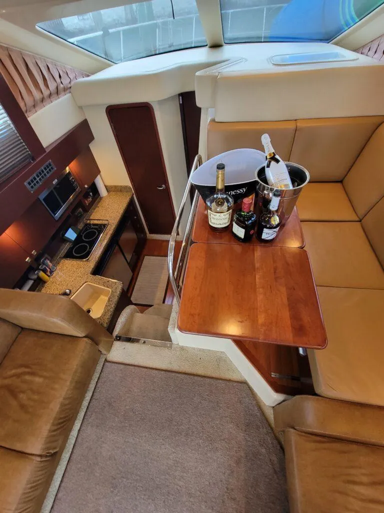 Slide: The Image of Interior of 2007 Sea Ray 360 Sedan with luxurious seating and a table with drinks. - 5