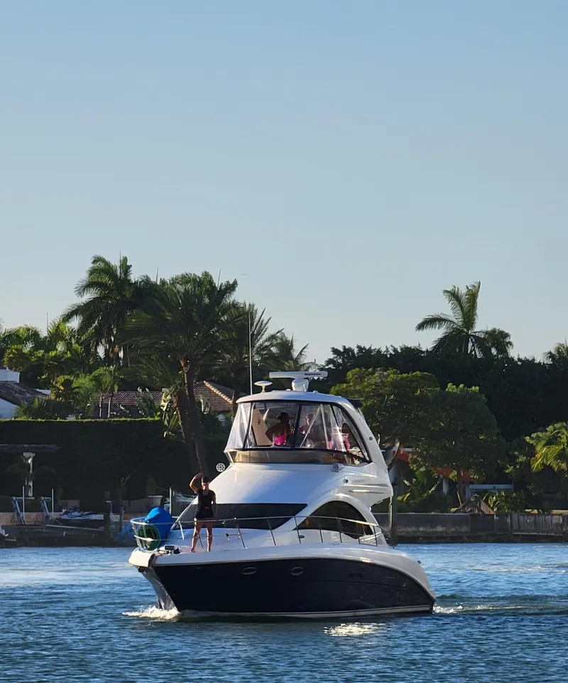 Slide: The Image of 2007 Sea Ray 360 Sedan cruising on a sunny day near palm trees. - 7