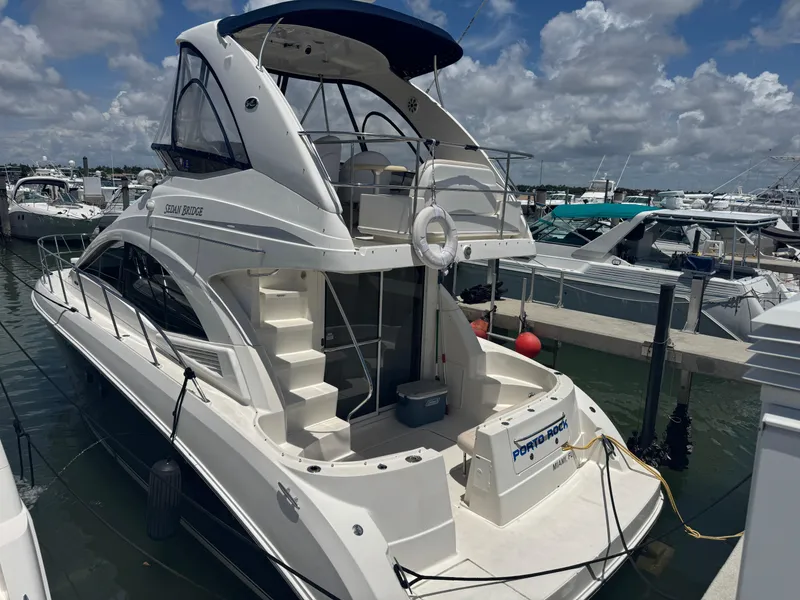 Slide: The Image of 2007 Sea Ray 360 Sedan yacht docked at marina under cloudy sky. - 8