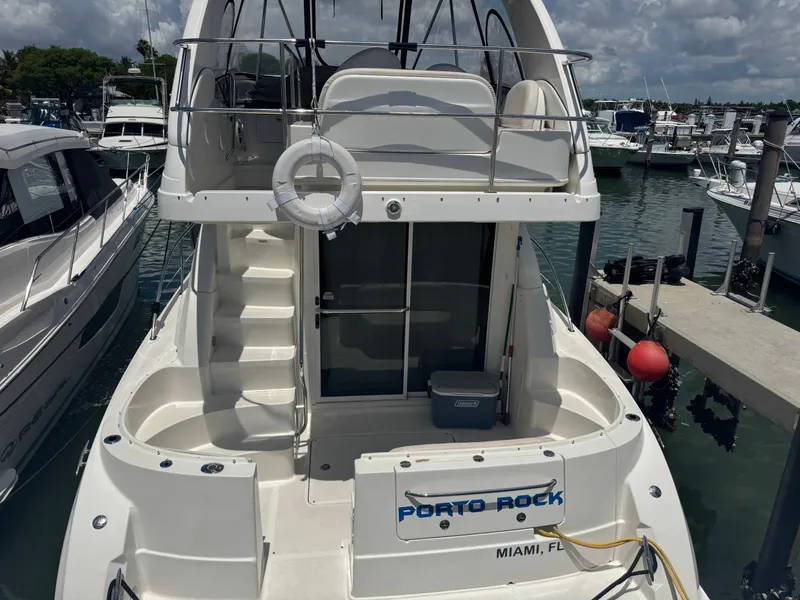 Slide: The Image of 2007 Sea Ray 360 Sedan docked in Miami marina, featuring upper deck and life preserver. - 9