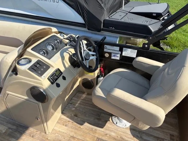 Slide: The Image of Captain's seat and helm of 2018 Crest I 220 SLC boat, featuring modern controls. - 4