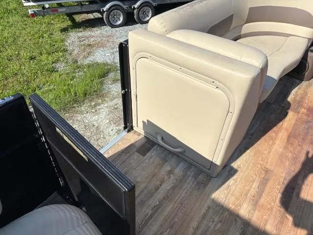 Slide: The Image of 2018 Crest I 220 SLC boat interior with beige seating and wood flooring. - 8