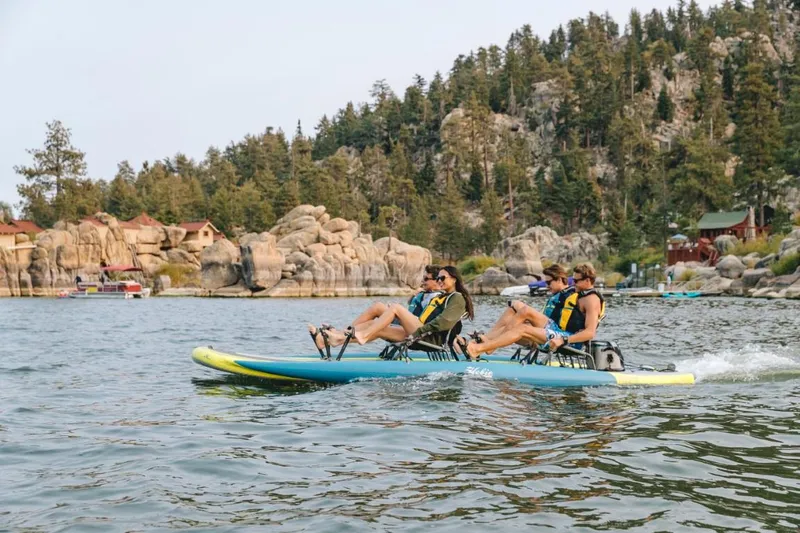 Slide: The Image of Four people enjoying a ride on a 2025 Hobie iTrek Fiesta pedal kayak. - 3