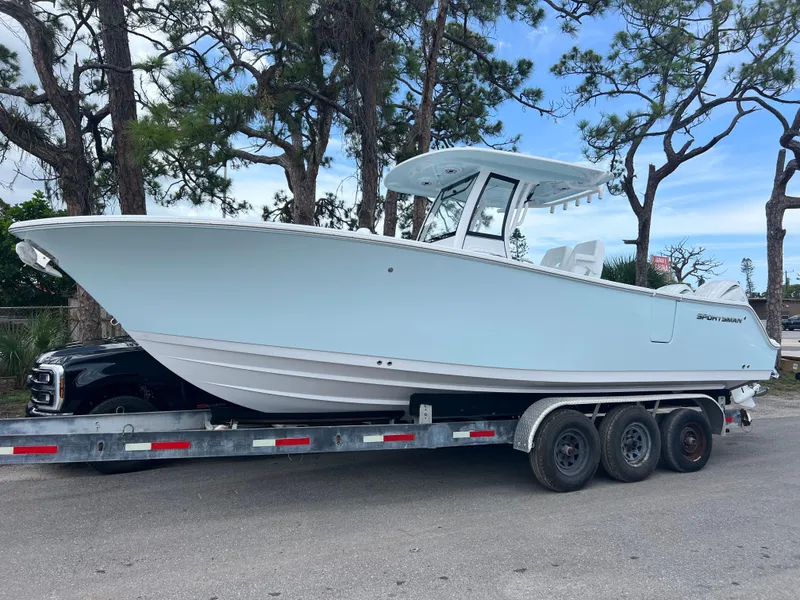 Slide: The Image of 2025 Sportsman Open 262 Center Console boat on trailer, parked outdoors. - 1
