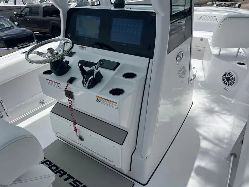 Slide: The Image of 2025 Sportsman Open 262 Center Console boat interior with steering wheel and control panel. - 10