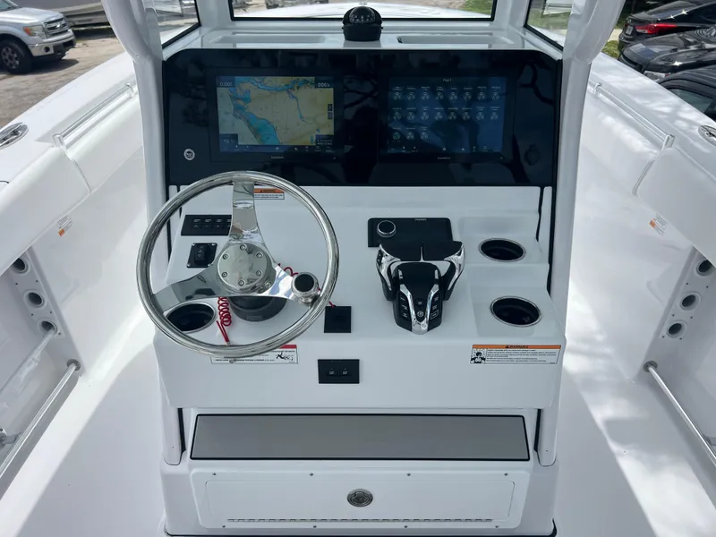 Slide: The Image of 2025 Sportsman Open 262 Center Console dashboard with steering wheel and navigation screens. - 11