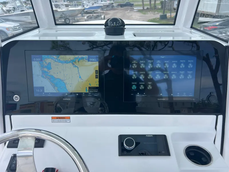 Slide: The Image of 2025 Sportsman Open 262 Center Console dashboard with dual Garmin displays and navigation controls. - 12