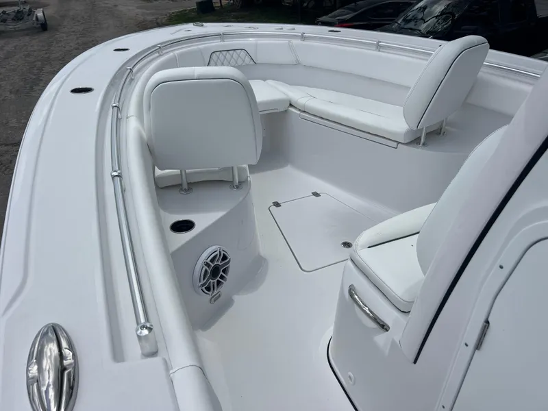 Slide: The Image of 2025 Sportsman Open 262 Center Console boat interior with white seating and speaker. - 13