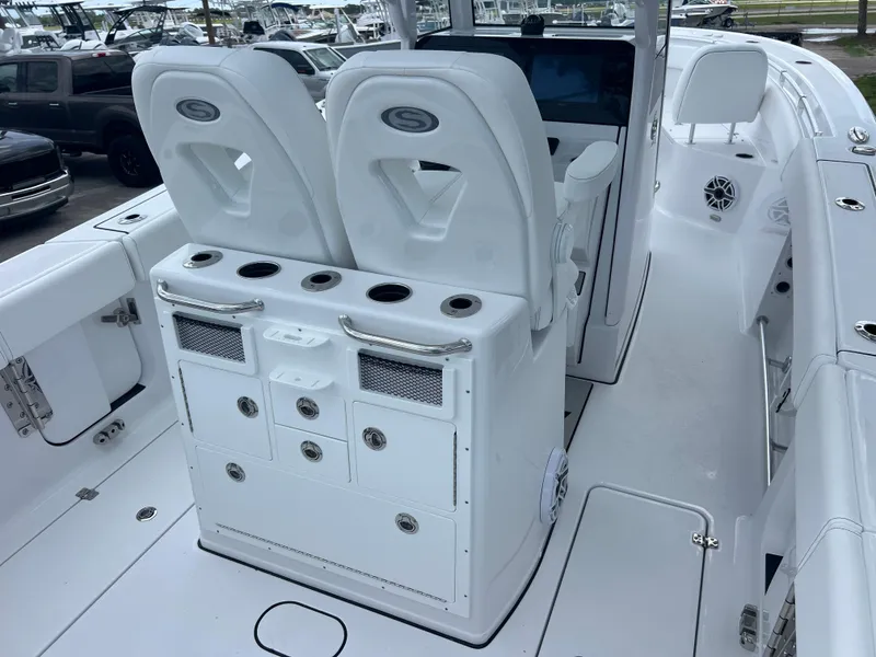 Slide: The Image of 2025 Sportsman Open 262 Center Console boat interior with dual seats and storage compartments. - 7