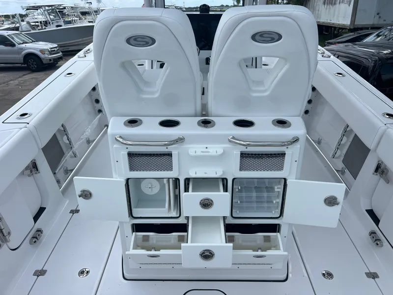 Slide: The Image of 2025 Sportsman Open 262 Center Console boat interior with storage compartments and seating. - 9