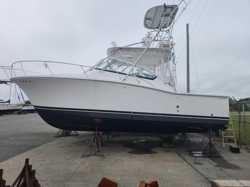 The Image of 2003 Luhrs 30 Open boat on stands, white hull, outdoor storage. - 1
