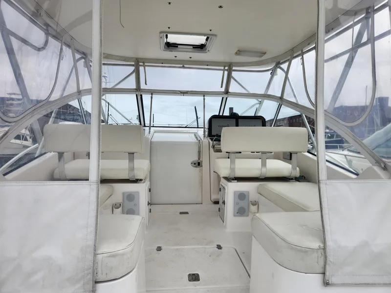 Slide: The Image of 2003 Luhrs 30 Open boat interior with white seating and clear enclosures. - 11