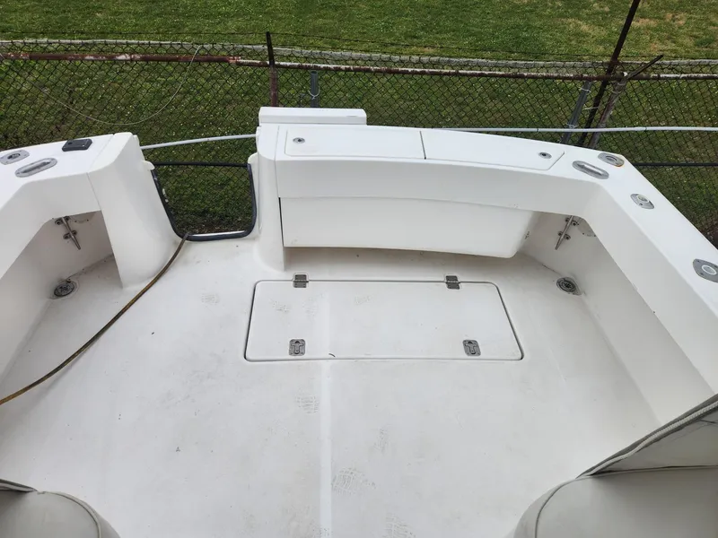 Slide: The Image of 2003 Luhrs 30 Open boat deck with storage compartments and clean white surface. - 12