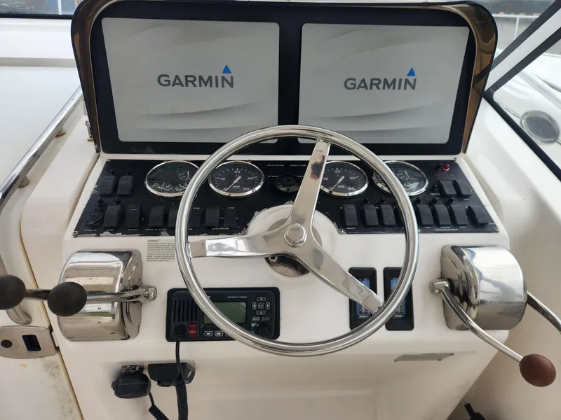 Slide: The Image of Helm of 2003 Luhrs 30 Open boat with Garmin displays and controls. - 13