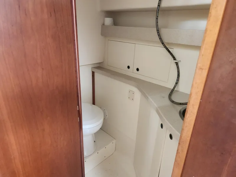 Slide: The Image of 2003 Luhrs 30 Open boat bathroom interior with toilet and sink. - 21