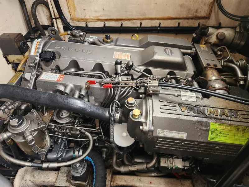 Slide: The Image of Engine compartment of a 2003 Luhrs 30 Open boat, featuring a Yanmar diesel engine. - 24