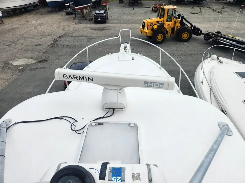 Slide: The Image of 2003 Luhrs 30 Open boat with Garmin xHD2 radar, docked near construction equipment. - 4