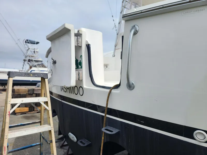 Slide: The Image of 2003 Luhrs 30 Open boat with ladder and docked setting. - 7