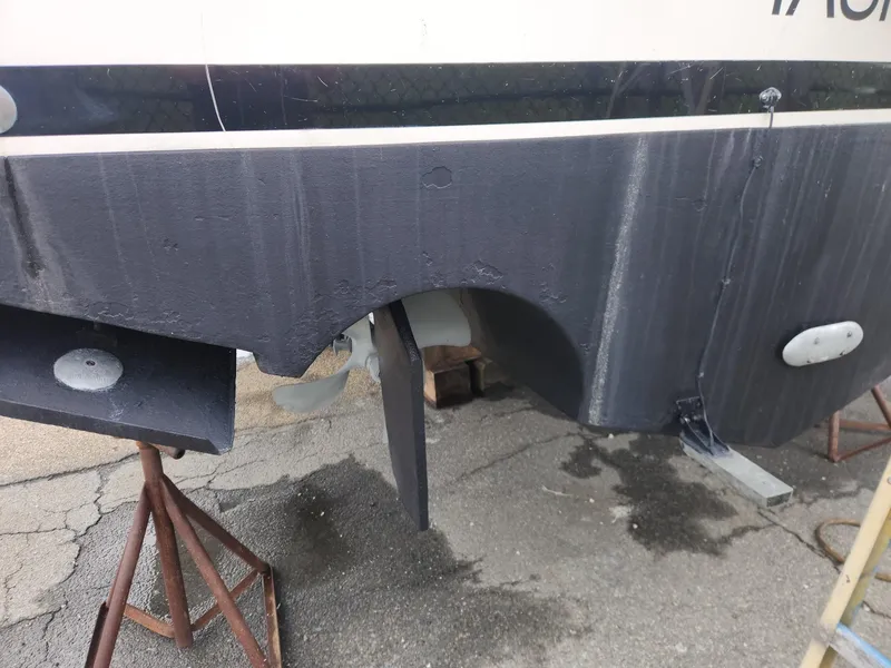 Slide: The Image of 2003 Luhrs 30 Open boat hull and propeller on stands. - 9