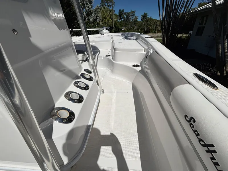 Slide: The Image of 2013 SeaHunter 24 Bay boat interior with rod holders and sleek design. - 17