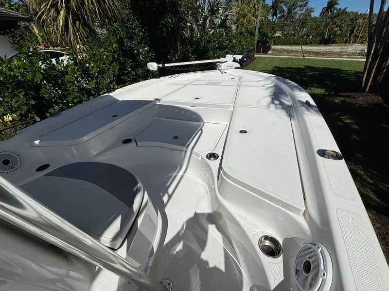 Slide: The Image of 2013 SeaHunter 24 Bay boat deck with seating and storage compartments. - 18