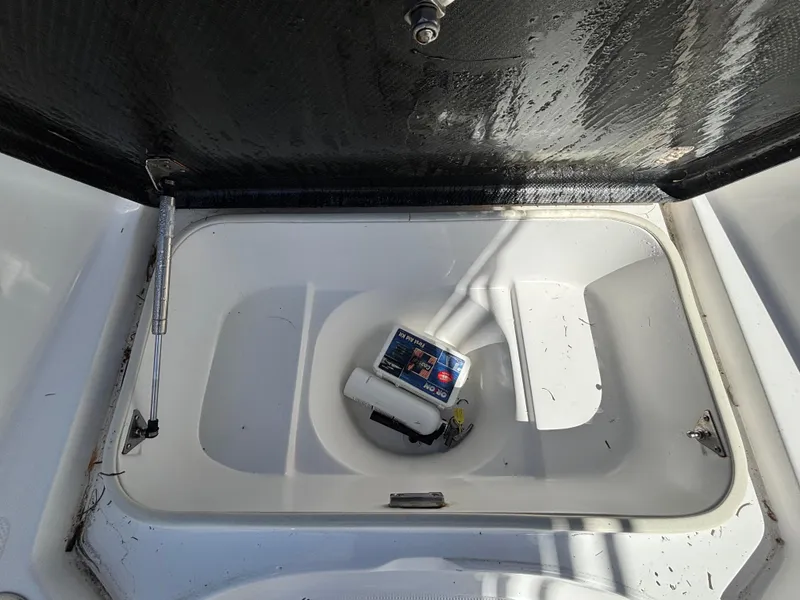 Slide: The Image of Open storage compartment in 2013 SeaHunter 24 Bay boat. - 21