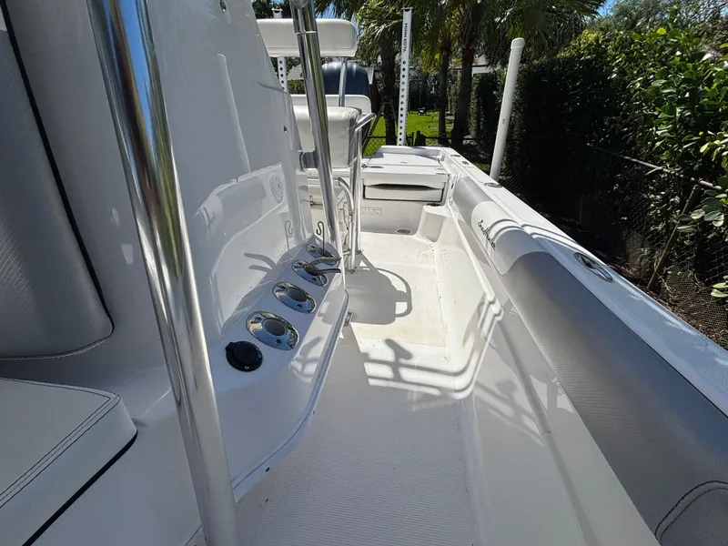 Slide: The Image of 2013 SeaHunter 24 Bay boat interior with sleek design and rod holders. - 26