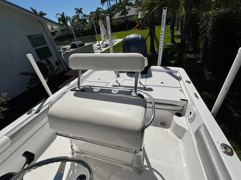 Slide: The Image of 2013 SeaHunter 24 Bay boat interior with seating and steering wheel. - 27