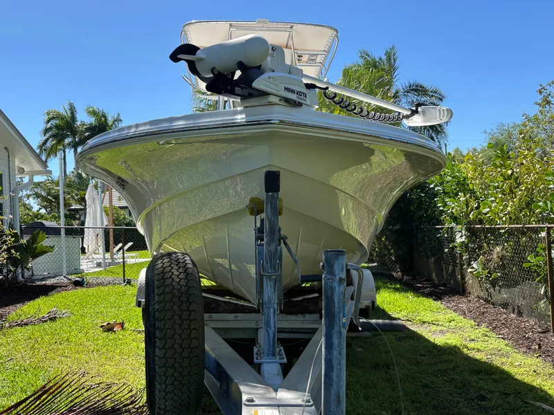 Slide: The Image of 2013 SeaHunter 24 Bay boat on trailer, parked in a sunny yard. - 3
