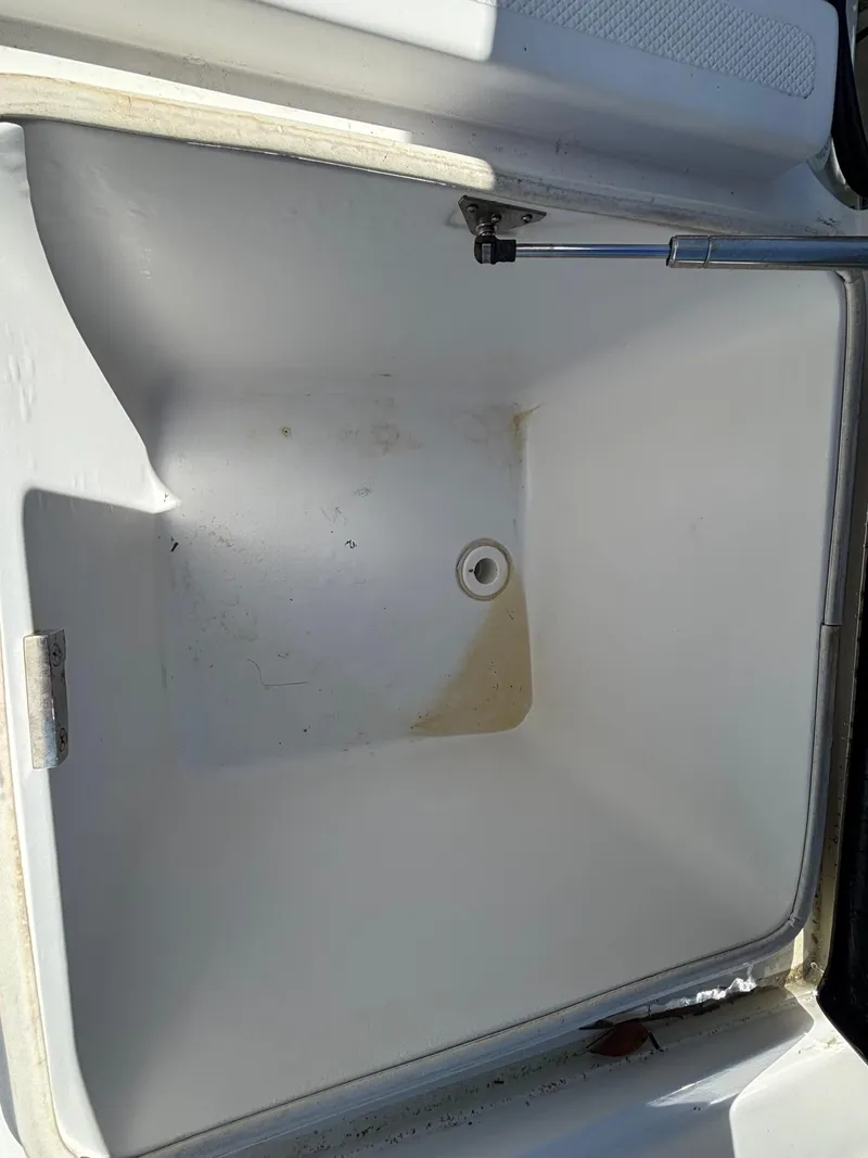 Slide: The Image of Open storage compartment on a 2013 SeaHunter 24 Bay boat. - 32