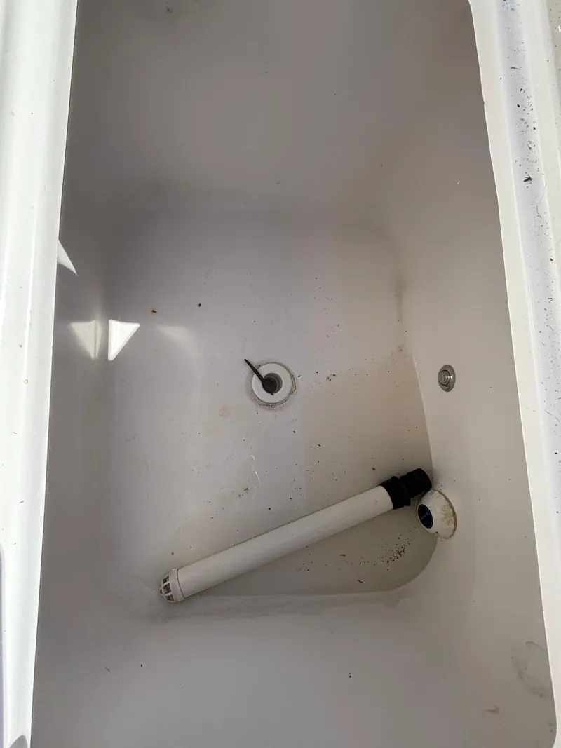 Slide: The Image of Empty storage compartment in 2013 SeaHunter 24 Bay boat. - 33