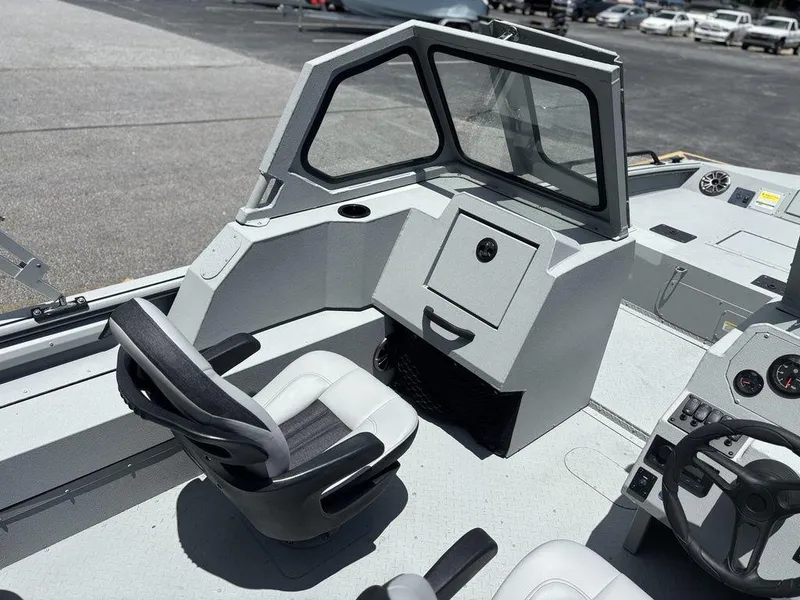 Slide: The Image of 2026 SeaArk ProCat 240 boat interior with seating and control panel. - 15
